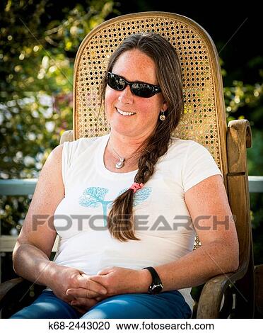 woman, 42, sits outside, smiling View Large Photo Image Stock Image - woman, 42, sits outside, smiling. Fotosearch