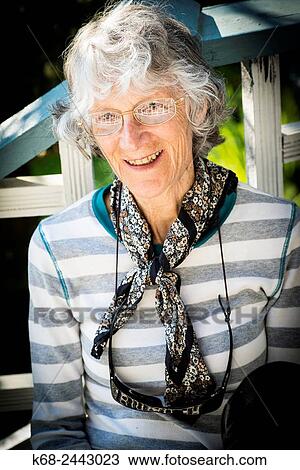 Woman, 77, smiling in an outdoor portrait View Large Photo Image Stock Image - Woman, 77, smiling in an outdoor portrait. Fotosearch