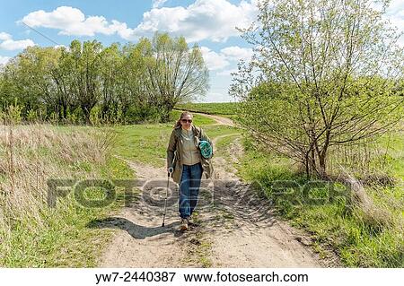 Woman having a walk in Kepa Kielpinska, Poland. View Large Photo Image Stock Photo - Woman having a walk in Kepa Kielpinska, Poland.. Fotosearch