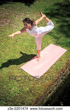 woman making yoga exercise in an old park. View Large Photo Image Picture - woman making yoga exercise in an old park.. Fotosearch