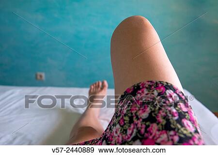 Woman´s legs lying on bed. Close view. View Large Photo Image Stock Photo - Woman´s legs lying on bed. Close view.. Fotosearch