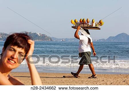 Stock Image - Woman selling fruit Manzanillo beach Pacific Ocean Colima Mexico North America.. Fotosearch