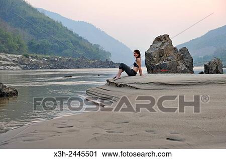 woman sitting on a sandbank of Mekong River, Pakbeng, Oudomxay Province, Laos, Southeast Asia. View Large Photo Image Stock Image - woman sitting on a sandbank of Mekong River, Pakbeng, Oudomxay Province, Laos, Southeast Asia.. Fotosearch