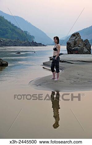 woman standing up on a sandbank on Mekong River, Pakbeng, Oudomxay Province, Laos, Southeast Asia. View Large Photo Image Stock Image - woman standing up on a sandbank on Mekong River, Pakbeng, Oudomxay Province, Laos, Southeast Asia.. Fotosearch