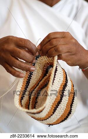 Woman weaving rucksack Arhuaca; Magdalena, Colombia. View Large Photo Image Picture - Woman weaving rucksack Arhuaca; Magdalena, Colombia.. Fotosearch