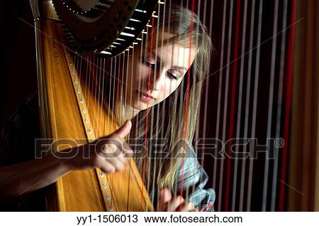 Young, female student at conservatoire playing harp at graduate level. View Large Photo Image Stock Image - Young, female student at conservatoire playing harp at graduate level.. Fotosearch