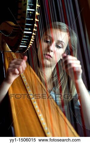 Young, female student at conservatoire playing harp at graduate level. View Large Photo Image Stock Photography - Young, female student at conservatoire playing harp at graduate level.. Fotosearch