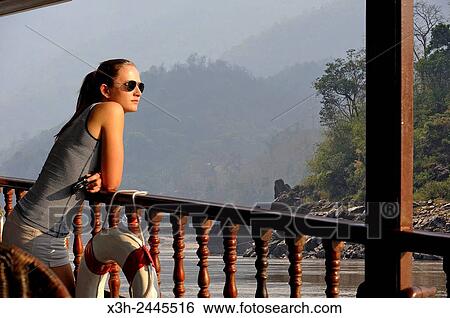 young woman standing at the railing of a cruise boat, owned by ´´ The Luang Say Lodge & Cruises´´, on Mekong River, between Pakbeng and Luang Prabang, Oudomxay Province, Laos, Southeast Asia. View Large Photo Image Stock Photograph - young woman standing at the railing of a cruise boat, owned by ´´ The Luang Say Lodge & Cruises´´, on Mekong River, between Pakbeng and Luang Prabang, Oudomxay Province, Laos, Southeast Asia.. Fotosearch