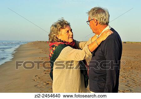 Stock Image - A couple on the beach. Ebro Delta Natural Park. Tarragona, Spain. Fotosearch