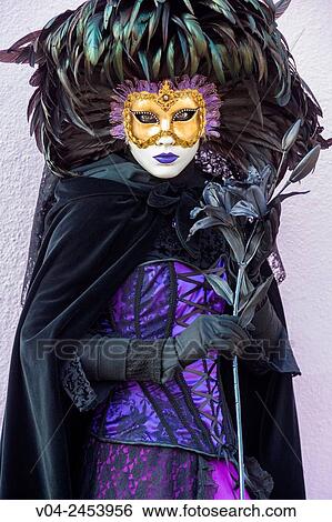 Stock Photograph - A masked woman at the carnival in Venice, Italy, Europe. Fotosearch