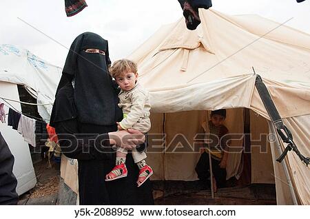 Al Za´atari, Al Mafraq region, Jordan, Middle-East. Many refugees from the civil war in Syria stay in the UNHCR refugee camp near Al Za´atari. Mothers and children live in tents and containers under generally harsh and primitive conditions. View Large Photo Image Stock Image - Al Za´atari, Al Mafraq region, Jordan, Middle-East. Many refugees from the civil war in Syria stay in the UNHCR refugee camp near Al Za´atari. Mothers and children live in tents and containers under generally harsh and primitive conditions.. Fotosearch