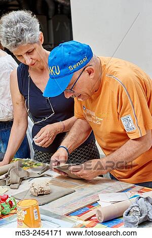 Amateur artists while modeling clay to obtain raku ceramics. View Large Photo Image Stock Image - Amateur artists while modeling clay to obtain raku ceramics.. Fotosearch