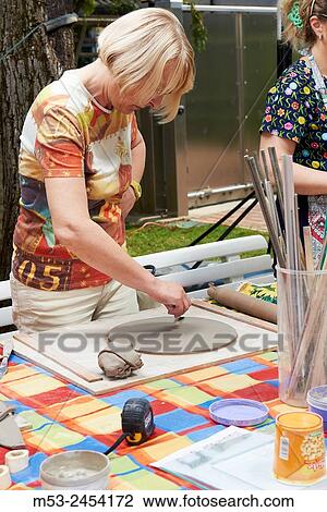 Amateur artists while modeling clay to obtain raku ceramics. View Large Photo Image Stock Image - Amateur artists while modeling clay to obtain raku ceramics.. Fotosearch