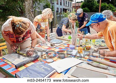 Amateur artists while modeling clay to obtain raku ceramics. View Large Photo Image Stock Image - Amateur artists while modeling clay to obtain raku ceramics.. Fotosearch