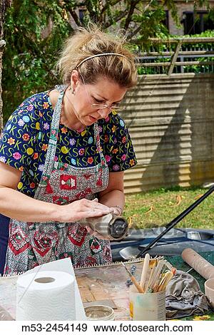 Amateur artists while modeling clay to obtain raku ceramics. View Large Photo Image Stock Photo - Amateur artists while modeling clay to obtain raku ceramics.. Fotosearch