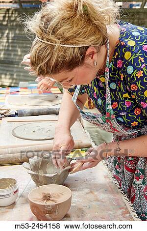 Amateur artists while modeling clay to obtain raku ceramics. View Large Photo Image Stock Photo - Amateur artists while modeling clay to obtain raku ceramics.. Fotosearch