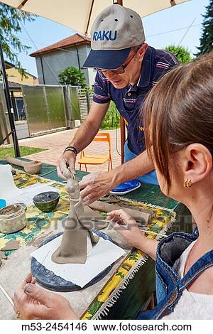 Amateur artists while modeling clay to obtain raku ceramics. View Large Photo Image Stock Photograph - Amateur artists while modeling clay to obtain raku ceramics.. Fotosearch