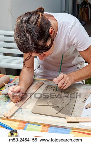 Amateur artists while modeling clay to obtain raku ceramics. View Large Photo Image Stock Photography - Amateur artists while modeling clay to obtain raku ceramics.. Fotosearch