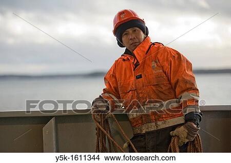 An Indonesian seaman or sailor on the container-vessel MV Flintercape, during a journey from Rotterdam, Netherlands, to Sundsvall, Sweden. The man is an ´Able Seaman´, who generally works on deck. View Large Photo Image Picture - An Indonesian seaman or sailor on the container-vessel MV Flintercape, during a journey from Rotterdam, Netherlands, to Sundsvall, Sweden. The man is an ´Able Seaman´, who generally works on deck.. Fotosearch