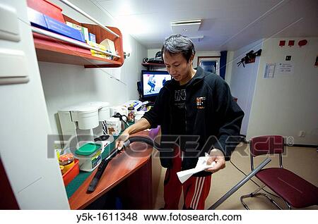 An Indonesian seaman or sailor on the container-vessel MV Flintercape, during a journey from Rotterdam, Netherlands, to Sundsvall, Sweden. The man is an ´Able Seaman´, who generally works on deck, and now cleans the interior of the wheelhouse. View Large Photo Image Stock Photo - An Indonesian seaman or sailor on the container-vessel MV Flintercape, during a journey from Rotterdam, Netherlands, to Sundsvall, Sweden. The man is an ´Able Seaman´, who generally works on deck, and now cleans the interior of the wheelhouse.. Fotosearch