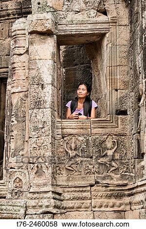 Contemplating the Bayon temple at Angkor Wat in Siem Reap, Cambodia. View Large Photo Image Stock Photo - Contemplating the Bayon temple at Angkor Wat in Siem Reap, Cambodia.. Fotosearch