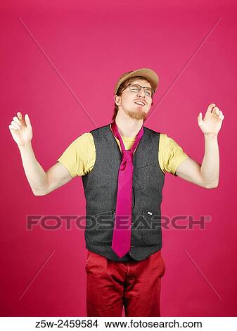Expressive hipster wearing a vest and pink tie, pink background and studio shot. View Large Photo Image Picture - Expressive hipster wearing a vest and pink tie, pink background and studio shot.. Fotosearch