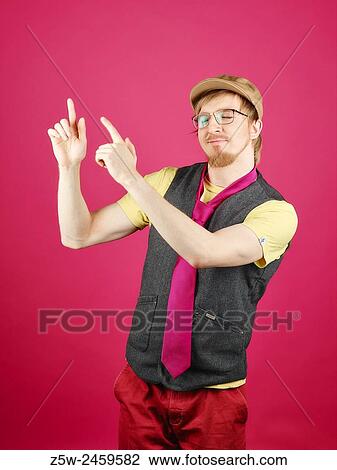 Expressive hipster wearing a vest and pink tie, pink background and studio shot. View Large Photo Image Stock Image - Expressive hipster wearing a vest and pink tie, pink background and studio shot.. Fotosearch