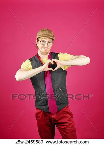 Expressive hipster wearing a vest and pink tie, pink background and studio shot. View Large Photo Image Stock Photo - Expressive hipster wearing a vest and pink tie, pink background and studio shot.. Fotosearch