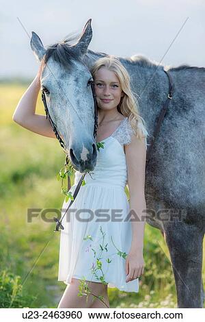 Stock Image - Girl with her horse.. Fotosearch