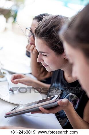 girls looking at a tablet in Benidorm, Spain View Large Photo Image Stock Photo - girls looking at a tablet in Benidorm, Spain. Fotosearch