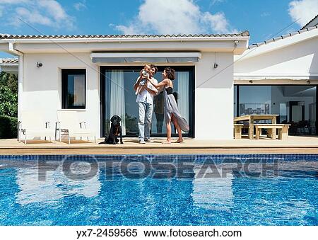Happy family on the terrace of there house. View Large Photo Image Stock Photography - Happy family on the terrace of there house.. Fotosearch