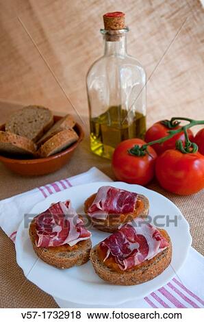 Stock Photo - Iberian ham with bread, olive oil and tomato sauce Spain. Fotosearch