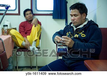 Stock Photo - Indonesian seamen or sailors on the container-vessel MV Flintercape, during a journey from Rotterdam, Netherlands, to Sundsvall, Sweden. The men are known as Â´Able SeamanÂ´, who generally work on deck. After work they eat and relax in the galley.. Fotosearch