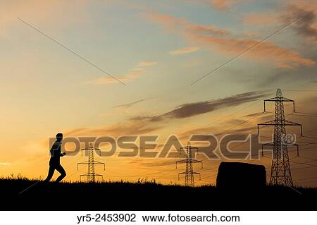 Man running through Hayfield at sunrise. Billingham, north east England, United Kingdom. View Large Photo Image Stock Image - Man running through Hayfield at sunrise. Billingham, north east England, United Kingdom.. Fotosearch