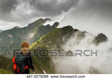 Stock Photograph - Mountaineer on Fagaras mountain. Southern Carpathians, Romania.. Fotosearch