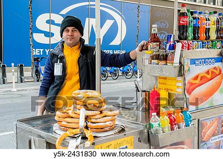 New York, USA. Arabic immigrant to the United States selling Hot Dogs & Pretsels from his mobile stand, Down Town Manhattan. View Large Photo Image Stock Image - New York, USA. Arabic immigrant to the United States selling Hot Dogs & Pretsels from his mobile stand, Down Town Manhattan.. Fotosearch