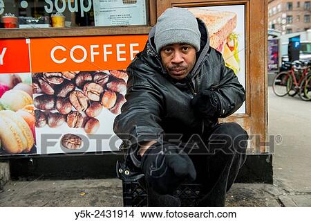 New York, USA. Homeless man of African American ethnicity, living in the streets of Manhattan, in front of a coffee shop. View Large Photo Image Picture - New York, USA. Homeless man of African American ethnicity, living in the streets of Manhattan, in front of a coffee shop.. Fotosearch