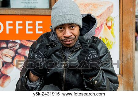 New York, USA. Homeless man of African American ethnicity, living in the streets of Manhattan, in front of a coffee shop. View Large Photo Image Stock Photography - New York, USA. Homeless man of African American ethnicity, living in the streets of Manhattan, in front of a coffee shop.. Fotosearch