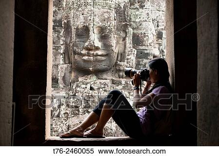 Photographer enjoying the Bayon temple at Angkor Wat in Siem Reap, Cambodia. View Large Photo Image Stock Photography - Photographer enjoying the Bayon temple at Angkor Wat in Siem Reap, Cambodia.. Fotosearch
