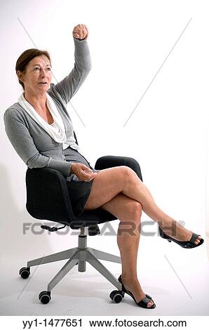 Stock Image - Portrait of a middle-aged woman, working as a secretary / management assistant. Studio-portait.. Fotosearch