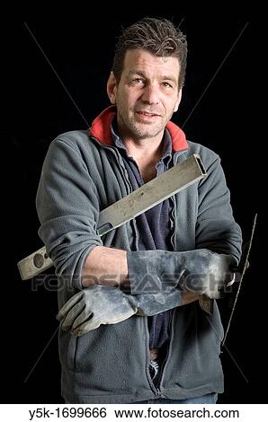 Portrait of a plasterer, with his tools, before a black background. Photograph - portrait taken during the reconstruction of a bathroom. View Large Photo Image Stock Photograph - Portrait of a plasterer, with his tools, before a black background. Photograph - portrait taken during the reconstruction of a bathroom.. Fotosearch