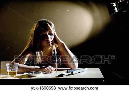 Rotterdam, Netherlands. Depressed young woman playing with a knife and drinking a glass of wiskey. View Large Photo Image Stock Photo - Rotterdam, Netherlands. Depressed young woman playing with a knife and drinking a glass of wiskey.. Fotosearch