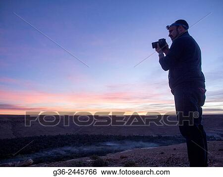 Silhouette of photographer during sunset, Morocco. View Large Photo Image Stock Photograph - Silhouette of photographer during sunset, Morocco.. Fotosearch