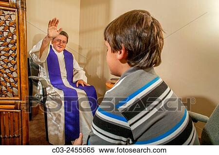 Sitting face to face, a priest gives absolution after hearing the confession of a boy parishioner at a Laguna Niguel, CA, Catholic church. Note vestments. MODEL RELEASE. View Large Photo Image Stock Photography - Sitting face to face, a priest gives absolution after hearing the confession of a boy parishioner at a Laguna Niguel, CA, Catholic church. Note vestments. MODEL RELEASE.. Fotosearch