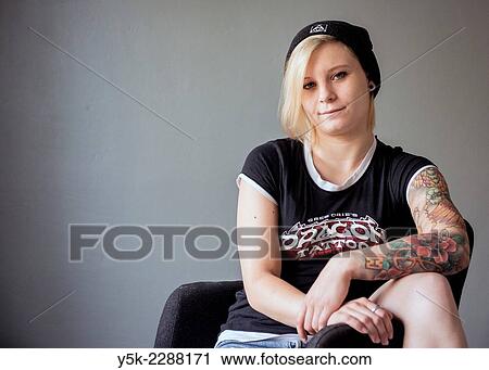 Studio Tuinstraat, Tilburg, Netherlands. Studio portrait of a young, blonde woman with large tatoo on her left arm. View Large Photo Image Stock Image - Studio Tuinstraat, Tilburg, Netherlands. Studio portrait of a young, blonde woman with large tatoo on her left arm.. Fotosearch