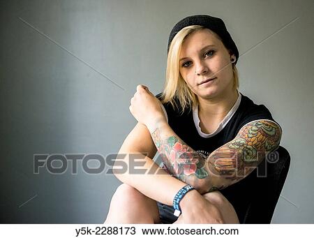 Studio Tuinstraat, Tilburg, Netherlands. Studio portrait of a young, blonde woman with large tatoo on her left arm. View Large Photo Image Stock Image - Studio Tuinstraat, Tilburg, Netherlands. Studio portrait of a young, blonde woman with large tatoo on her left arm.. Fotosearch