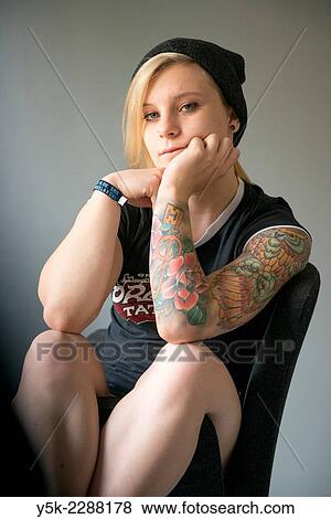 Studio Tuinstraat, Tilburg, Netherlands. Studio portrait of a young, blonde woman with large tatoo on her left arm. View Large Photo Image Stock Photo - Studio Tuinstraat, Tilburg, Netherlands. Studio portrait of a young, blonde woman with large tatoo on her left arm.. Fotosearch