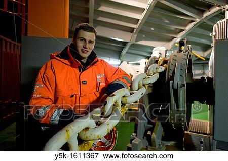 The Dutch Cadet at container-vessel MV Flintercape, on the prow or front of the ship. He leans against the chains, connected to the ships anchor. View Large Photo Image Stock Photo - The Dutch Cadet at container-vessel MV Flintercape, on the prow or front of the ship. He leans against the chains, connected to the ships anchor.. Fotosearch