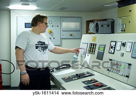 Picture - The second engineer of container-vessel MV Flintercape controls the engine-room of the vessel during absence of the first engineer. The ship is sailing from Rotterdam, Netherlands to Sundsvall, Sweden.. Fotosearch