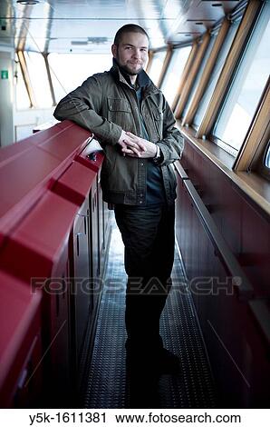 Stock Image - The second officer of container-vessel MV Flintercape controls the bridge of the vessel during absence of the captain and the first officer. The ship is sailing from Rotterdam, Netherlands to Sundsvall, Sweden.. Fotosearch